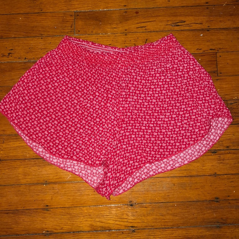 red flowy shorts with pink floral print